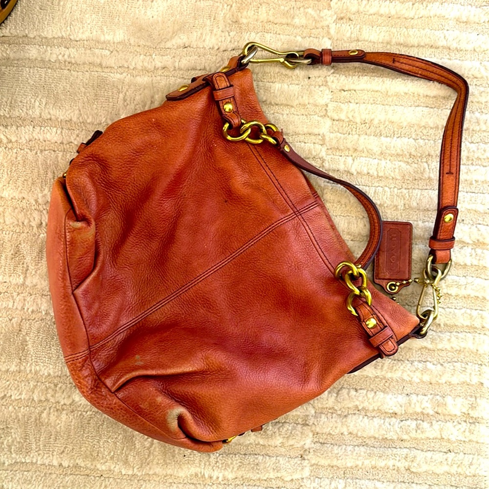 Pre-loved, needs some leather conditioner and love. Rose colored COACH purse